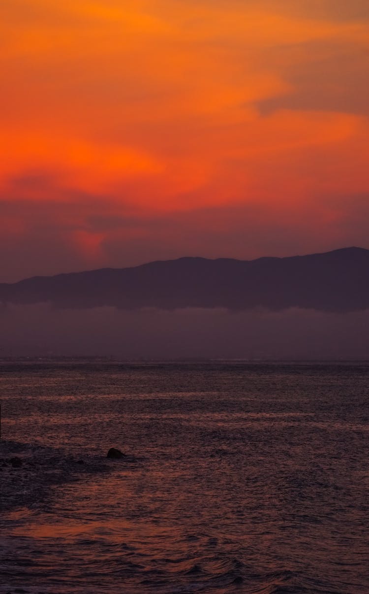 Silhouette Of Mountain Near Sea