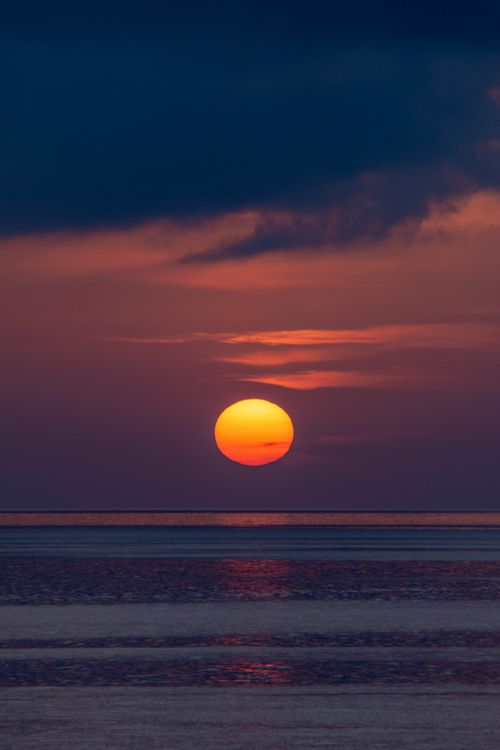 Free Stunning sunset view over the sea in Bagnara Calabra, Calabria, Italy, with rich colors and serene waters. Stock Photo