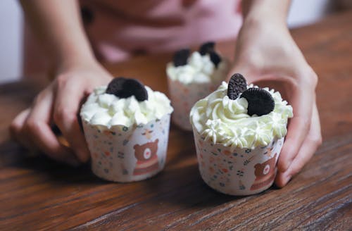 Person Holding Cupcakes