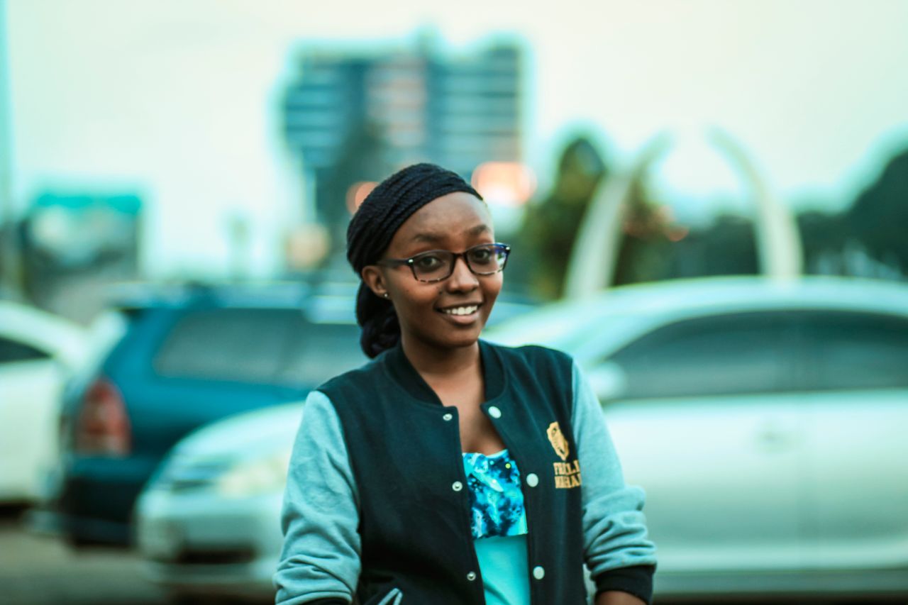 smiling woman wearing glasses and a jacket outdoors in nairobi kenya u