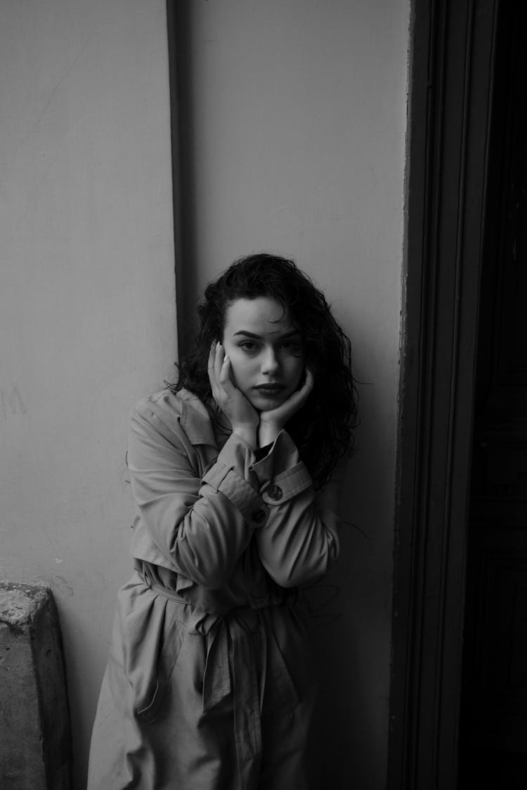 Woman In Trench Coat Posing Near Wall