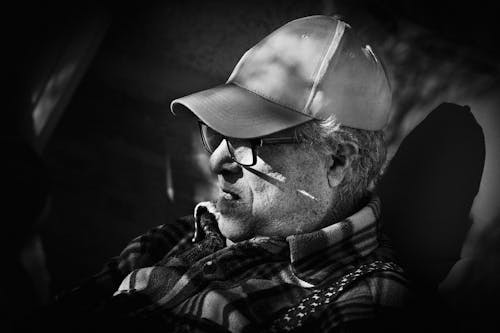 Black and White Photo of Man Wearing Cap