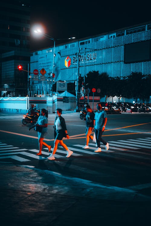 People Crossing the Street at Night Time