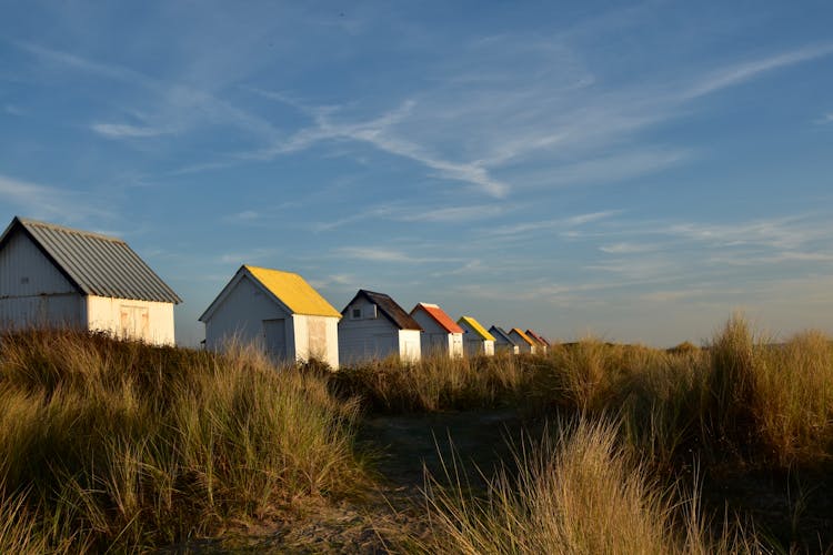 Wooden Cabin At The Beach With Coloured Roofs