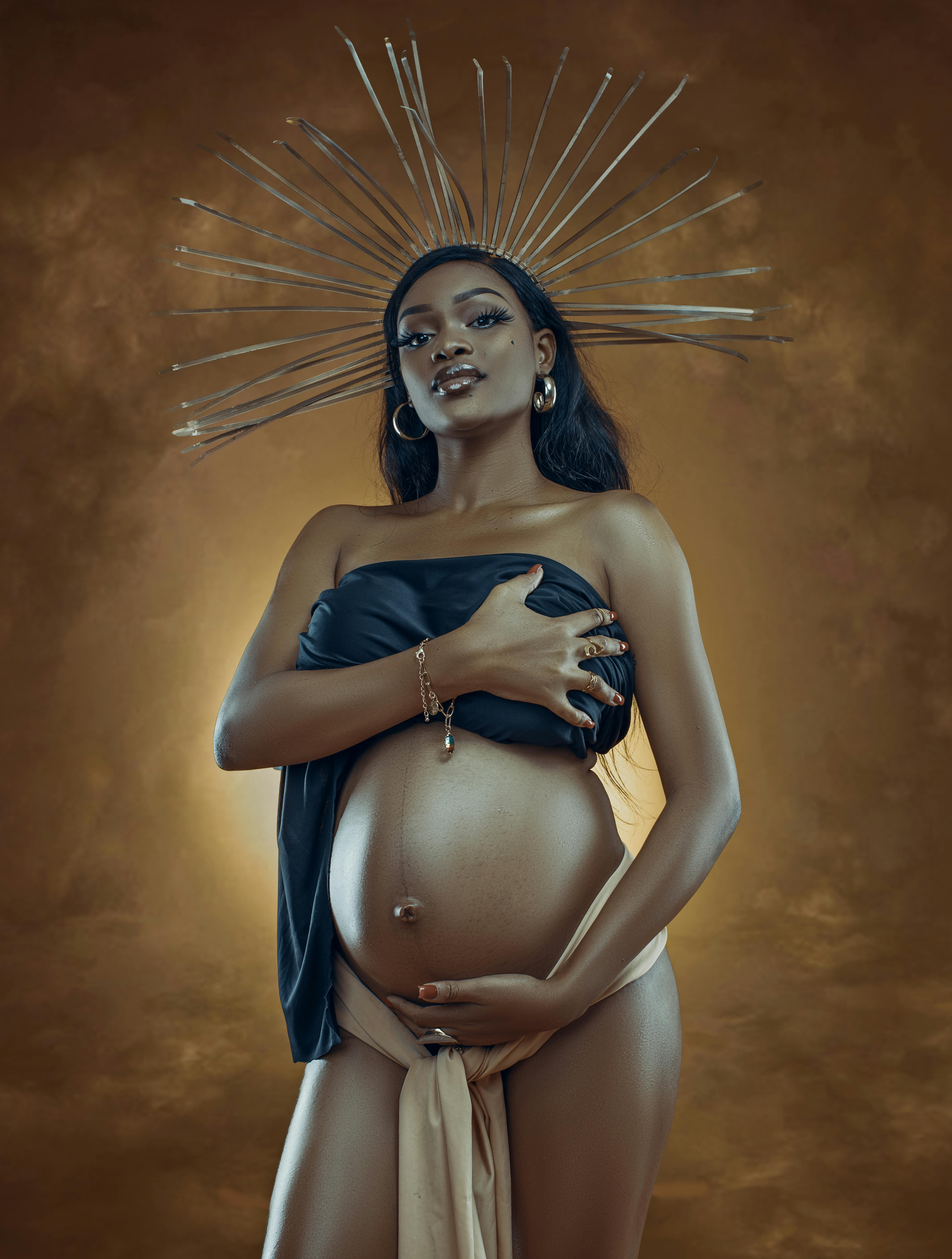 pregnant woman posing in crown