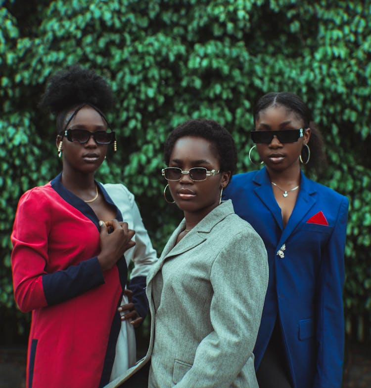 Women In Suits Posing In Garden