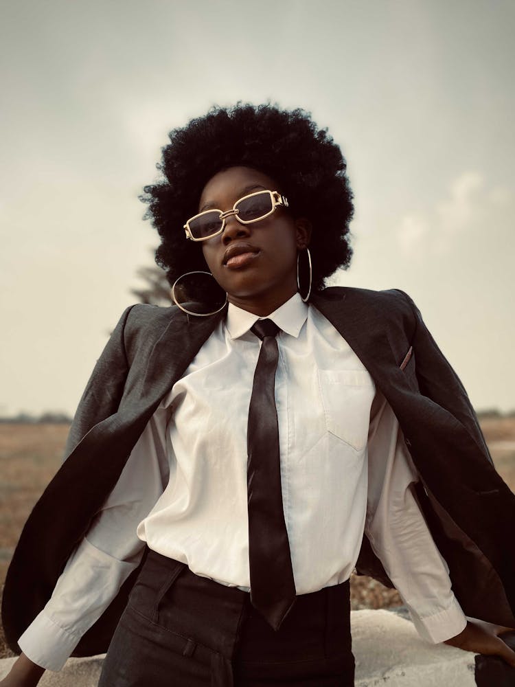 Woman In Suit And Sunglasses Posing In Nature