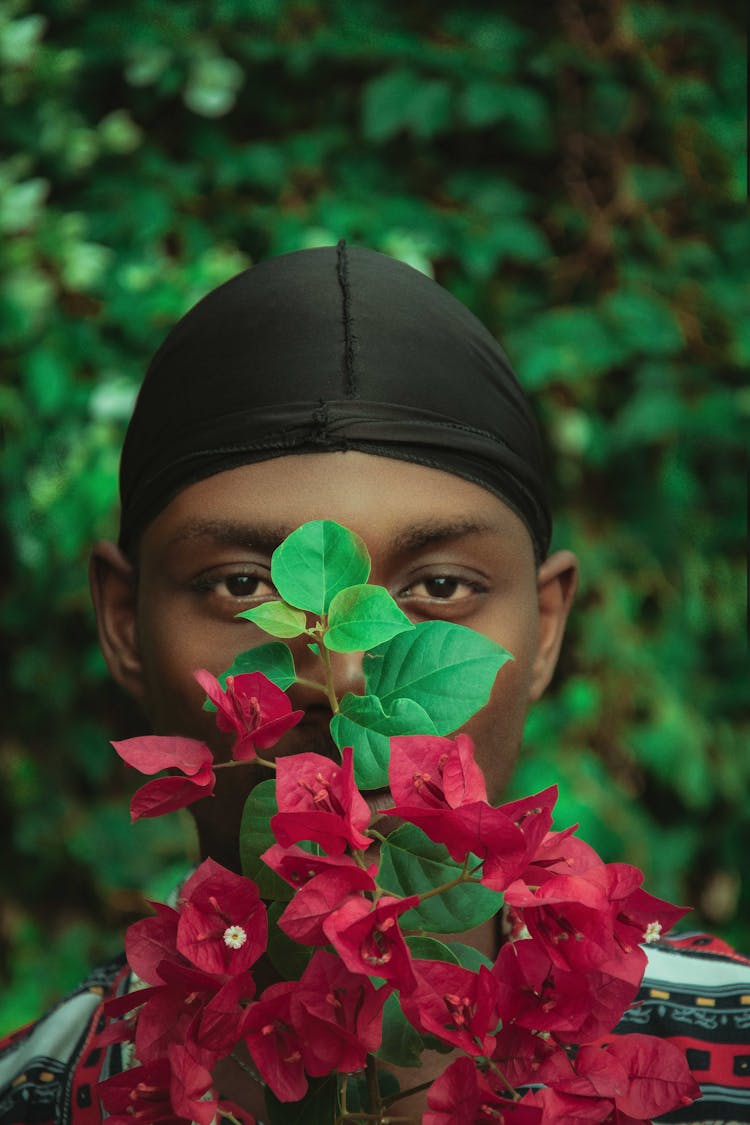 Man In Bandana Posing With Flowers In Garden