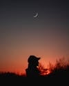 Free Silhouette of Person Wearing Cap under Crescent Moon Stock Photo