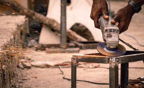 Person Grinding a Metal