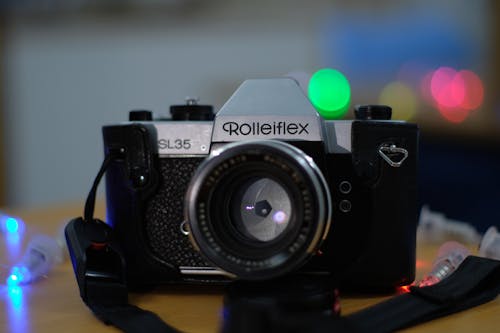 Black Camera on Brown Wooden Table