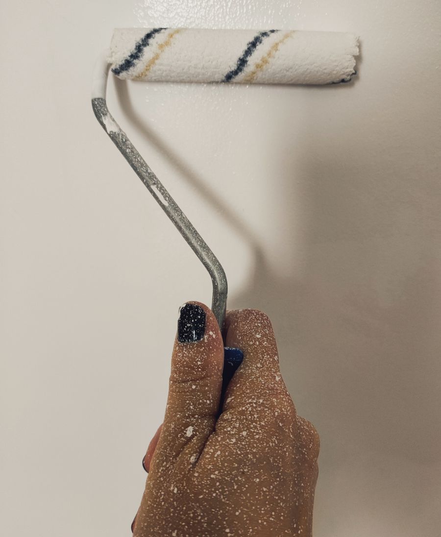 Close-up of a paint roller applying wall color