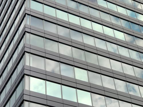 Free Close-up view of a modern skyscraper glass facade in Szczecin, reflecting the sky. Stock Photo