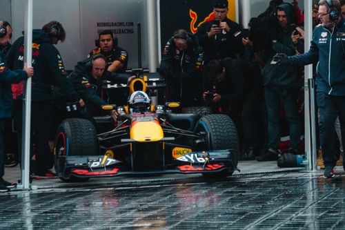 Free Exciting Formula One car during a dynamic pit stop, showcasing teamwork and precision. Stock Photo