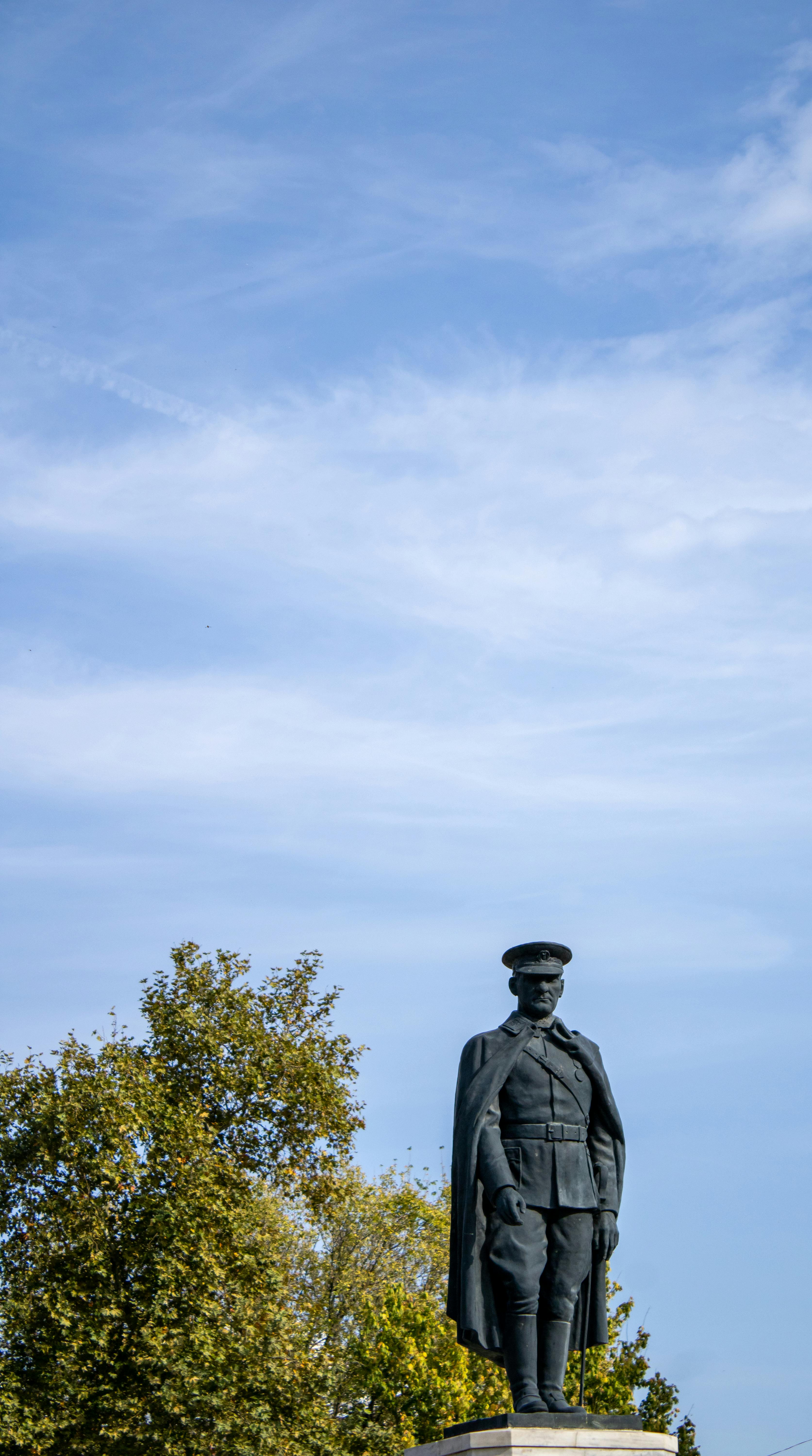 statue of a man under blue sky