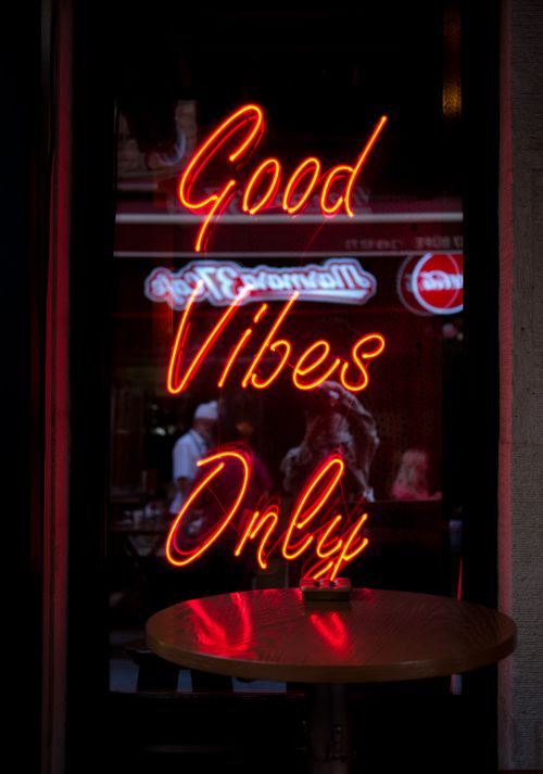 Free Neon sign displaying 'Good Vibes Only' in vibrant red, perfect for urban inspiration. Stock Photo