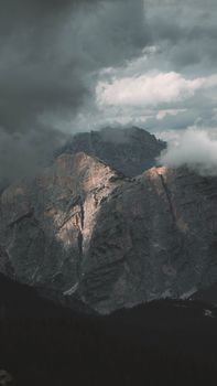 Captivating view of rugged mountain peaks partially shrouded in clouds at Cortina d'Ampezzo, Italy. 13860066