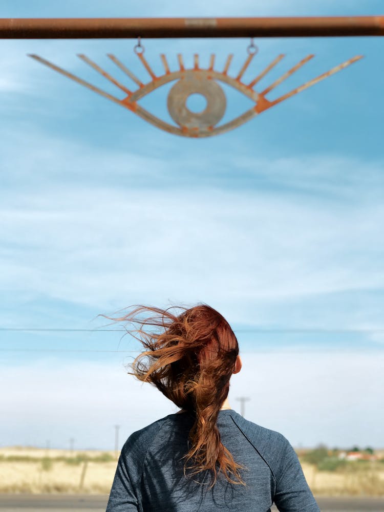 Woman Standing Under Sign Of Eye