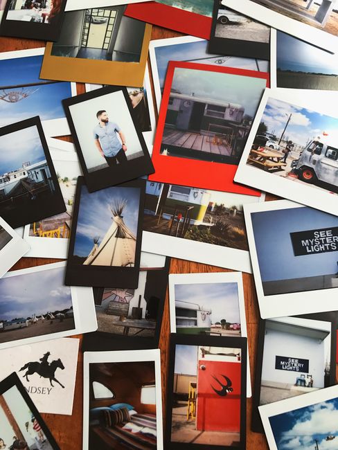A collection of scattered polaroid photos depicting various scenes and memories in vibrant colors.