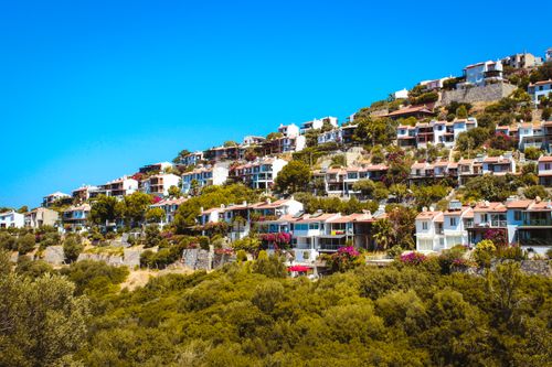 Free Picturesque hillside town in Bodrum, Türkiye with vibrant vegetation and clear blue skies. Stock Photo