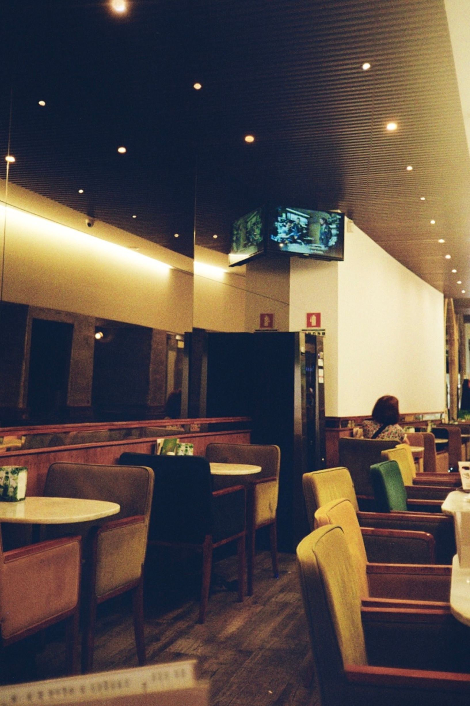 Cozy empty cafe interior with ambient lighting and stylish furniture.