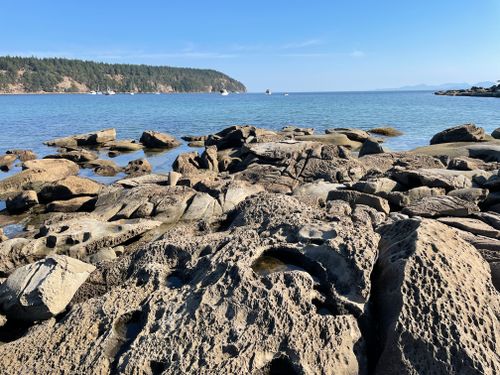 Free Scenic view of a rocky coastline with cliffs and blue sea under a clear summer sky. Stock Photo
