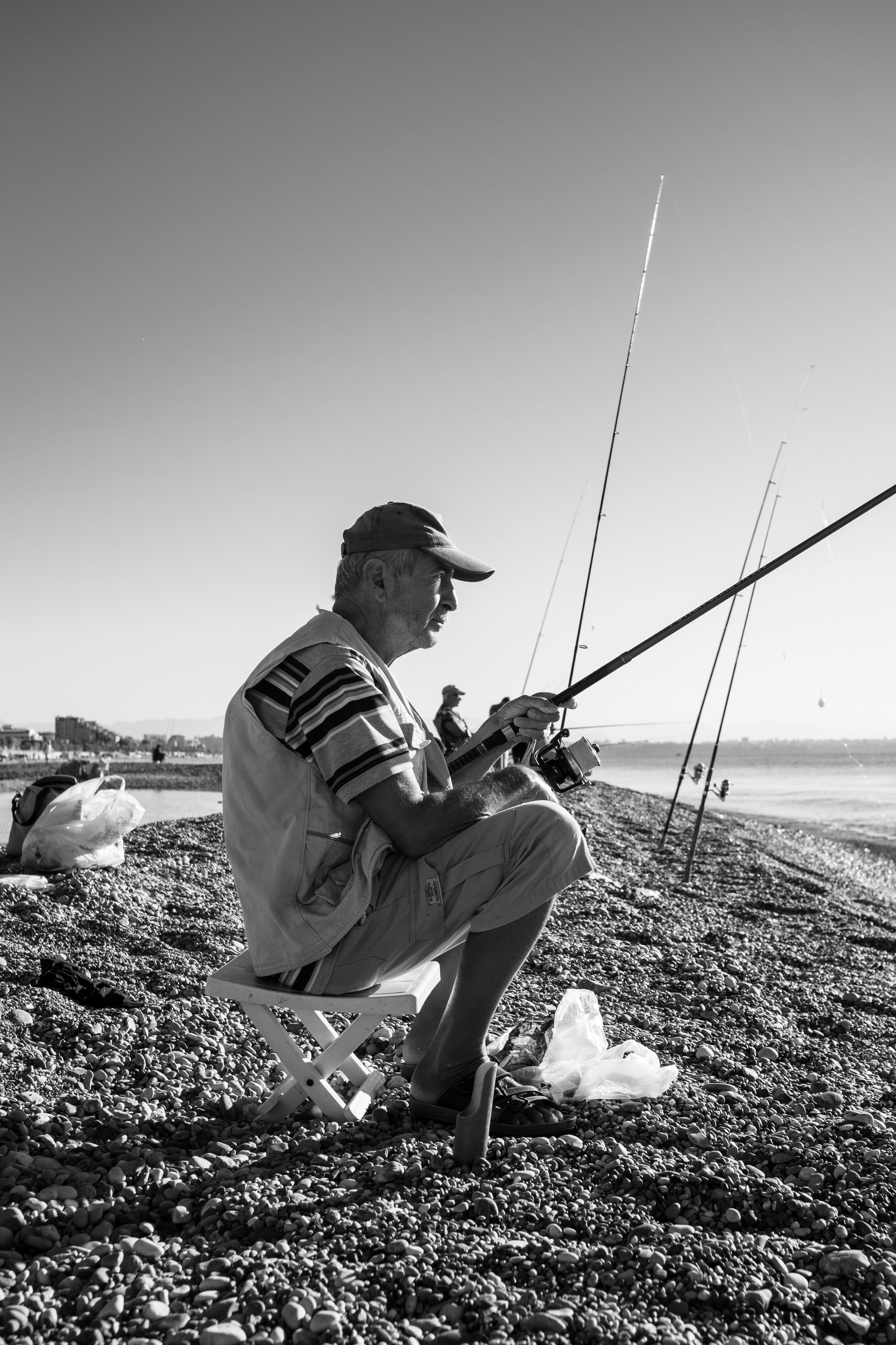 A Man Sitting While Using Fishing Rod · Free Stock Photo