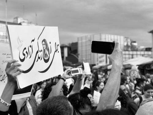 Free A black and white protest scene featuring raised arms and signs in Istanbul. Stock Photo