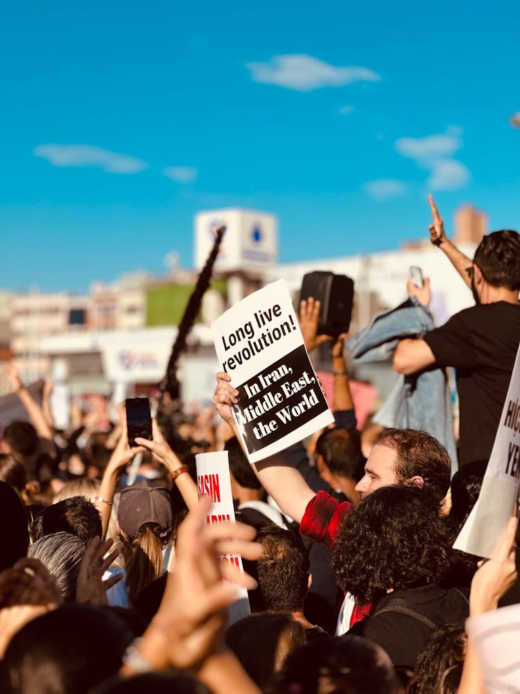 Crowd Of People Holding Posters Protesting On Street