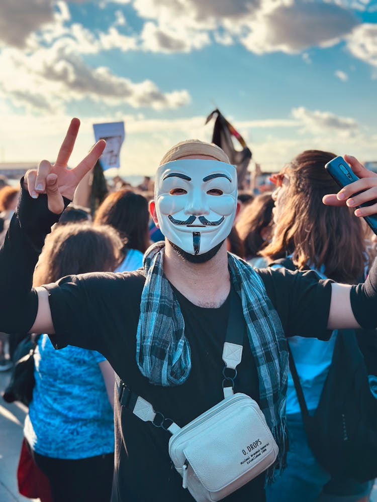 A Man In Black Shirt Wearing A Mask