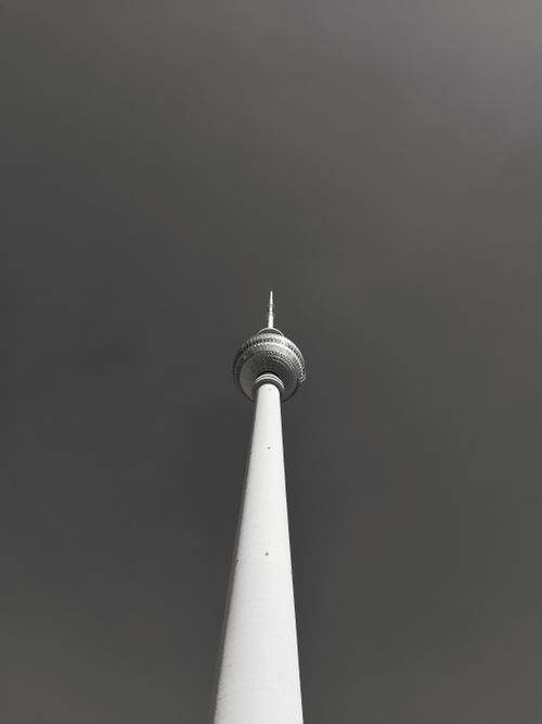 Free Low-angle view of Berlin's Television Tower in monochrome, emphasizing modern architecture. Stock Photo