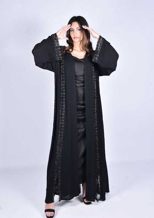 A Woman Wearing Black Dress and Black Abaya