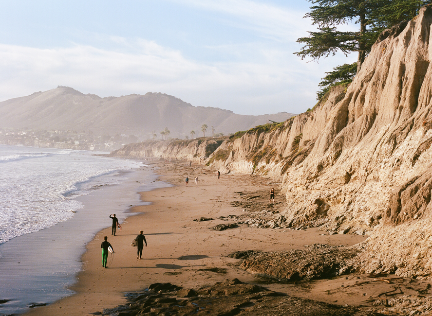 Experience the serene beauty of Pismo Beach with its dramatic cliffs and calming ocean waves.