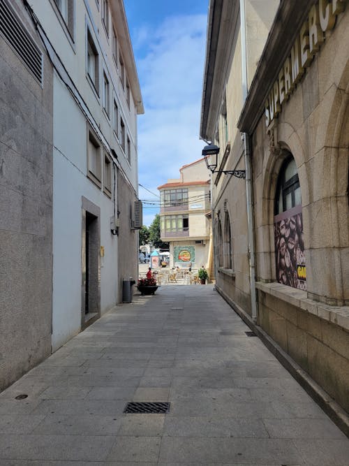 An Empty Street Between Concrete Buildings