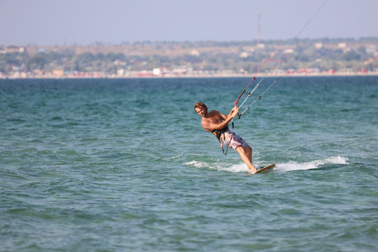 Man Surfing On Wake Board