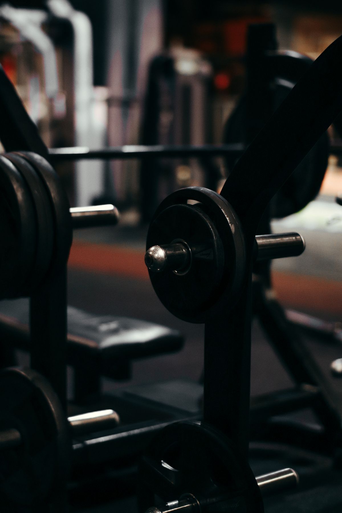 Loaded barbell in a dark gym