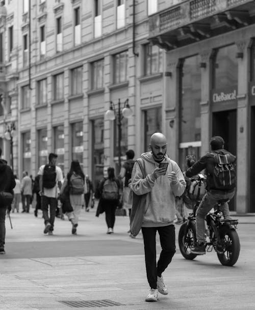 Grayscale Photo of People Walking on Sidewalk