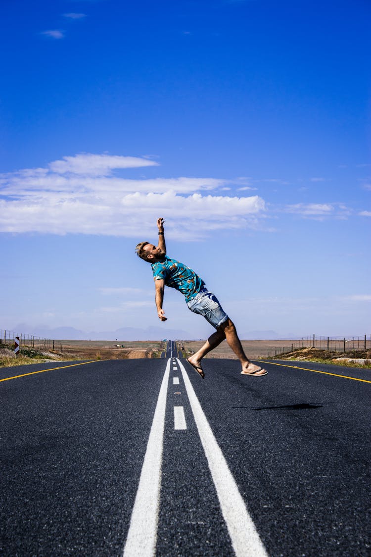 Man Posing On Empty Road