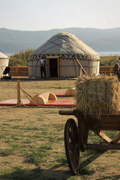 Yurt on a Field and a Cart with Hay 