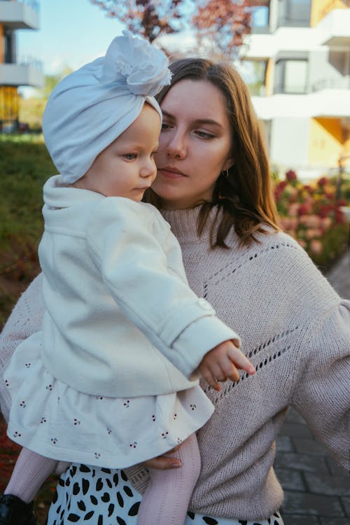 Photo of a Mother Carrying Her Baby