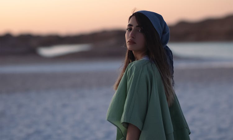 Woman In Green Top Standing Wearing Bandana