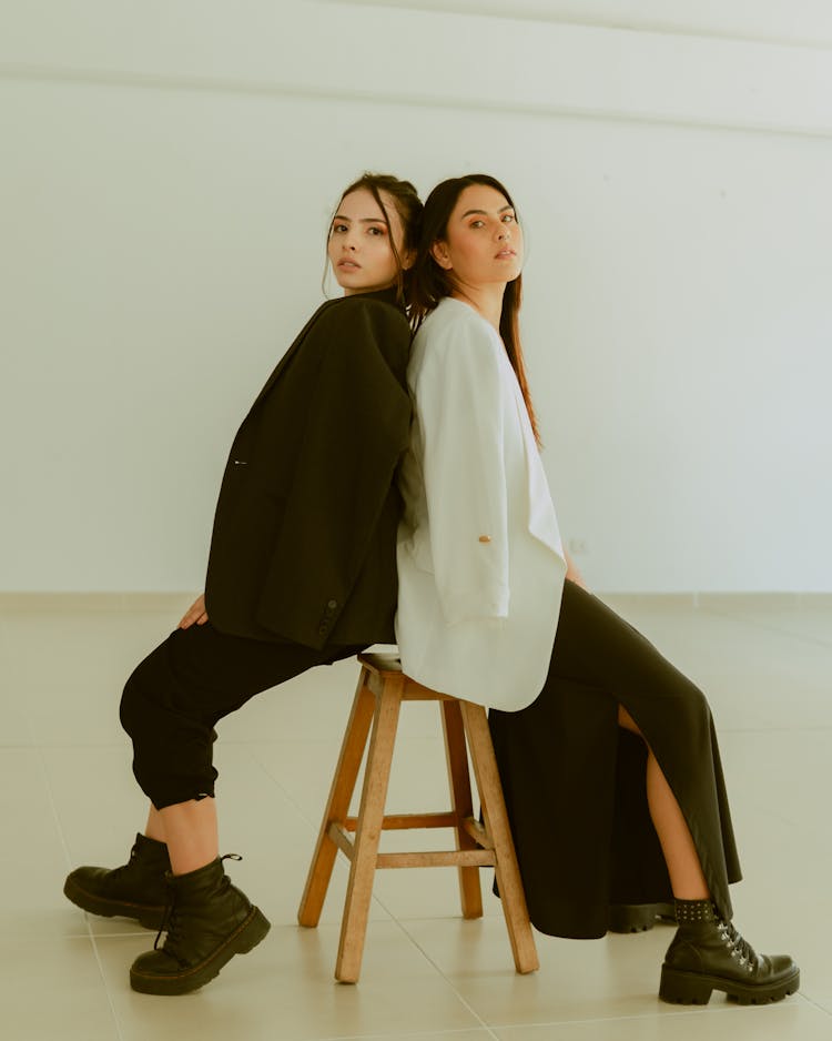 Two Women Sitting On A Chair