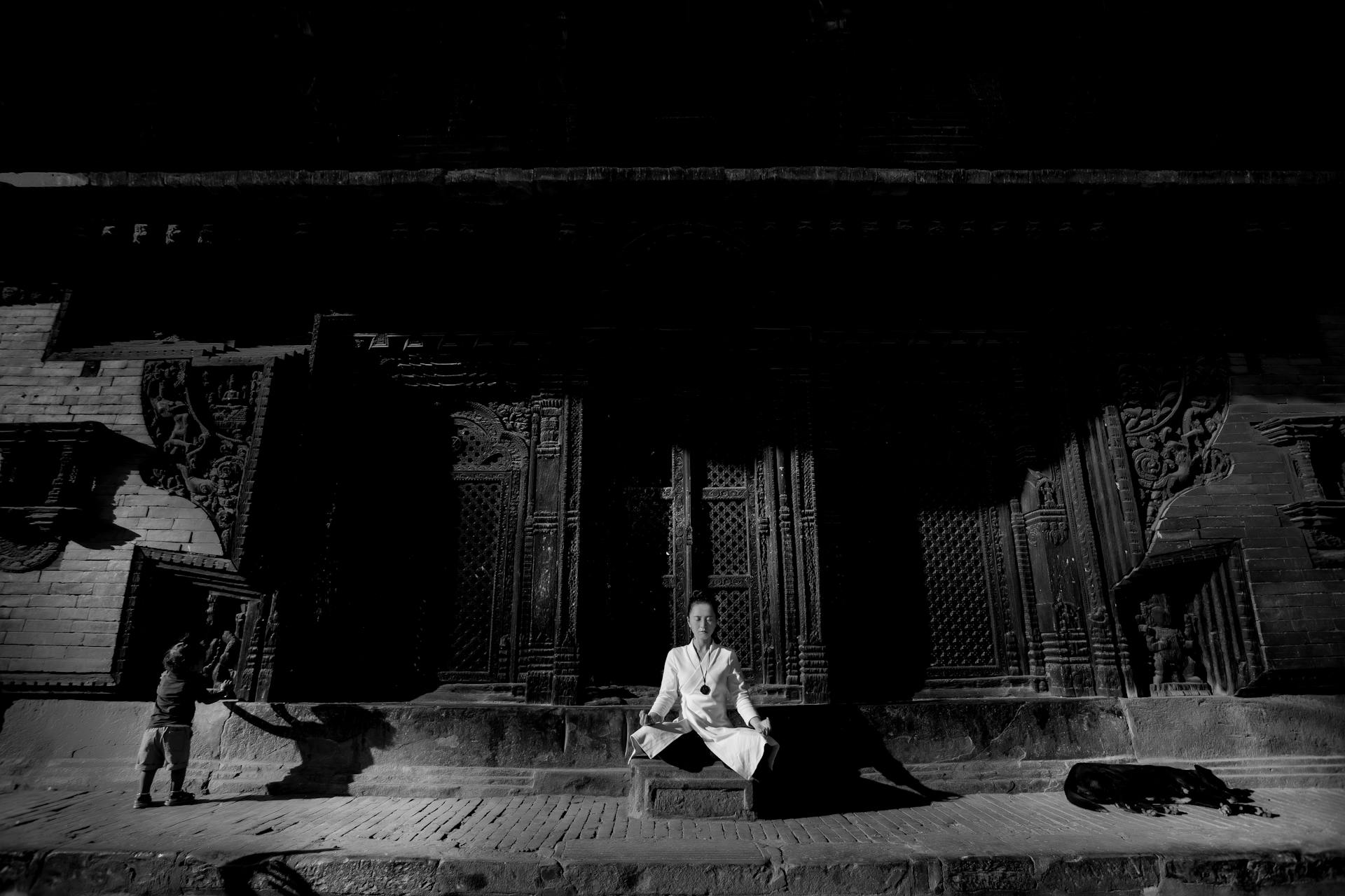 Grayscale Photo of Man Sitting on Floor