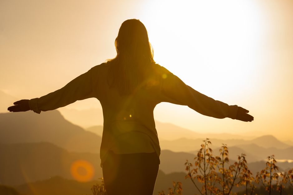 person hiking or enjoying a scenic view, symbolizing a fresh start - holistic rehabilitation