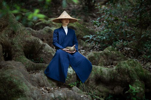 Woman Meditating on Tree Roots