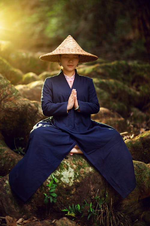 Woman Sitting on Rock Meditating 