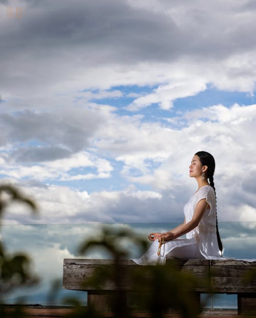 Woman Meditating Against the Sky