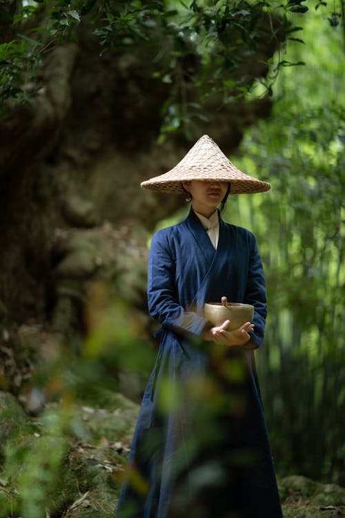 Woman in Blue Long Sleeve Dress Holding a Singing Bowl