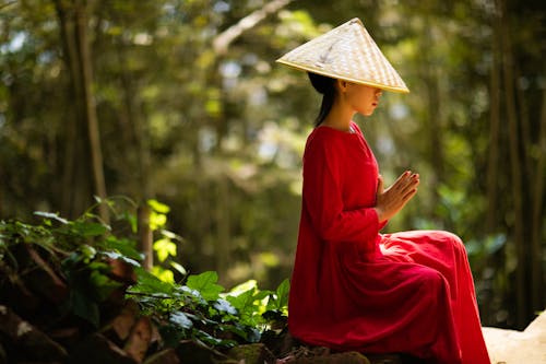 Woman in Red Dress Wearing Conical Hat