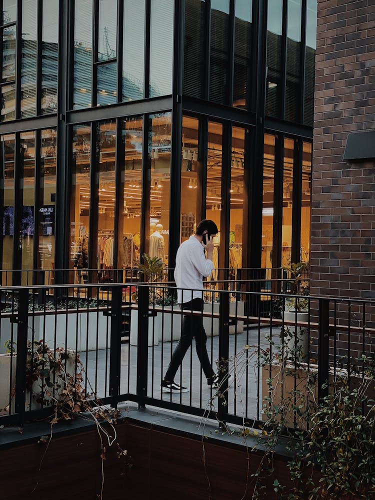 Man Walking And Talking On Telephone 